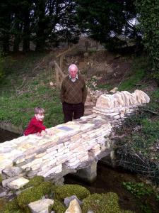 With Grandson at Restored Clapper Bridge at Signet 